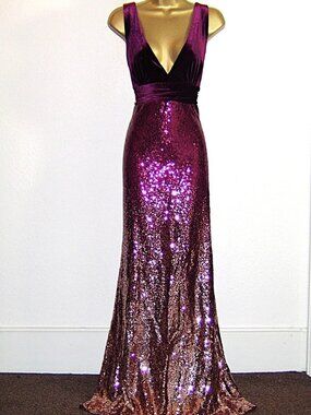 A long evening dress with a wine red to gold gradient and glittering sequins.
